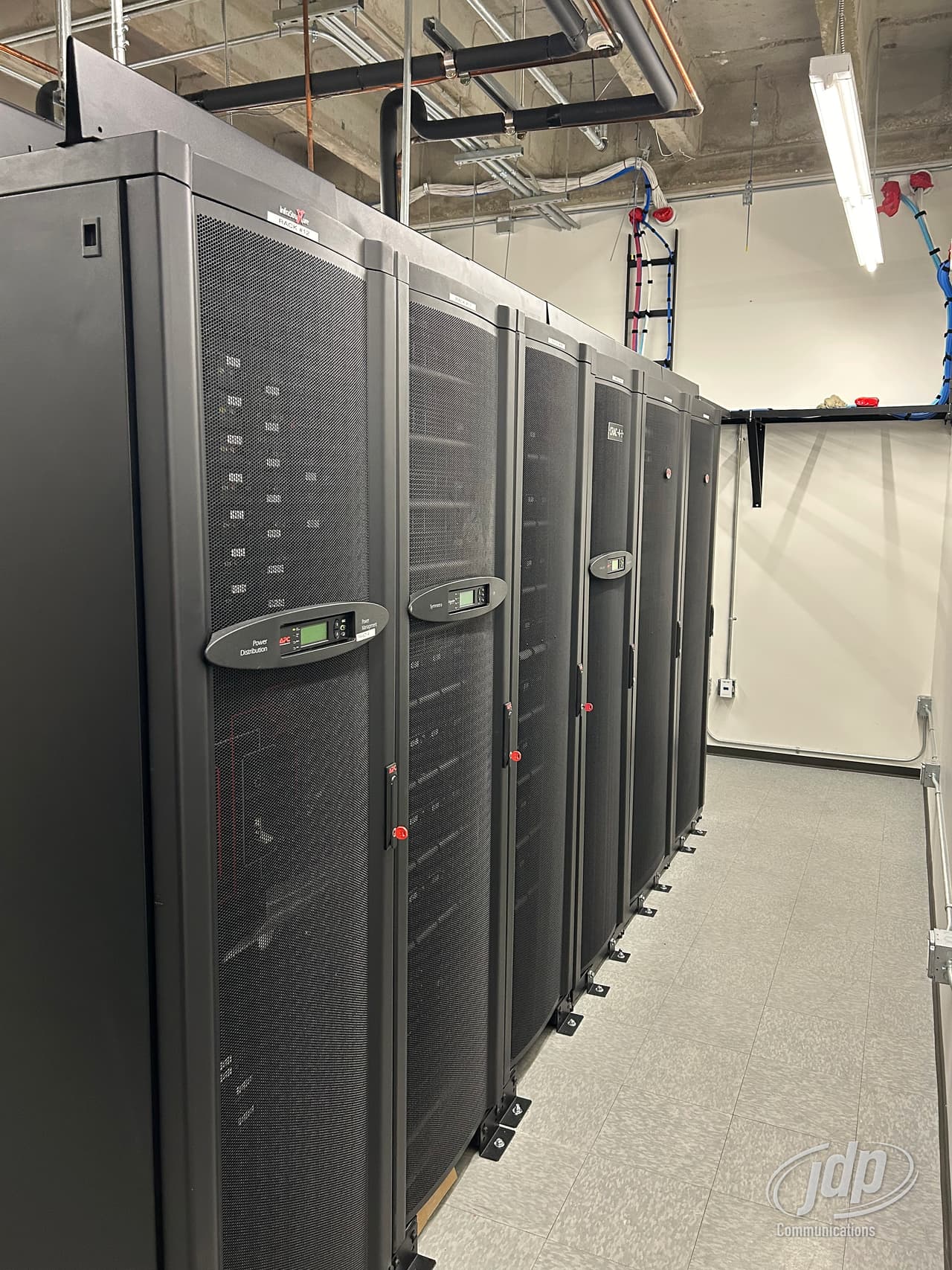 Row of server cabinets along a data center aisle